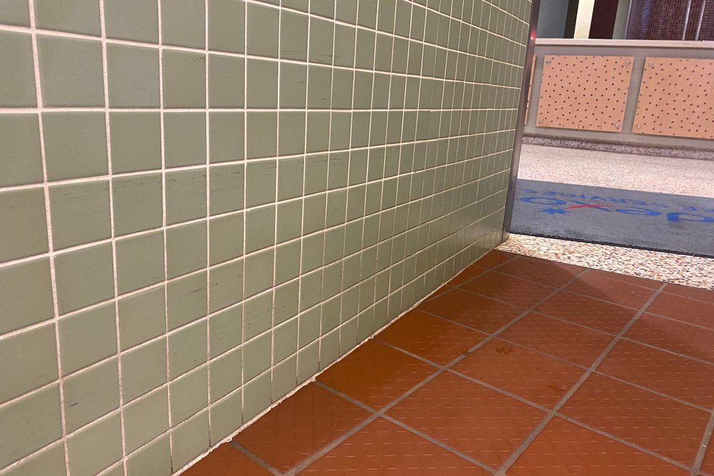 Cleaned tiled wall and red quarry tile floor with the grout lines restored to an even colour
